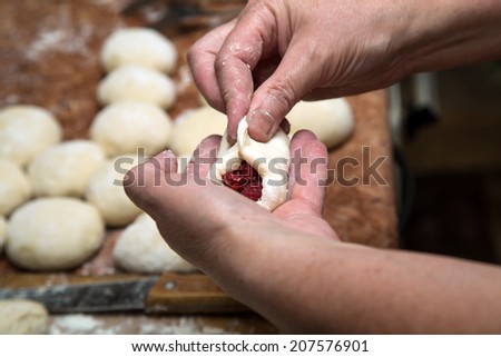 woman hands making cakes with berries