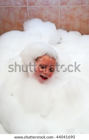 The boy in bath the filled foam