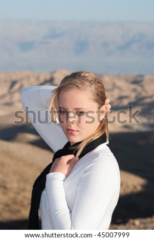 The young blonde in white blouse and black scarf