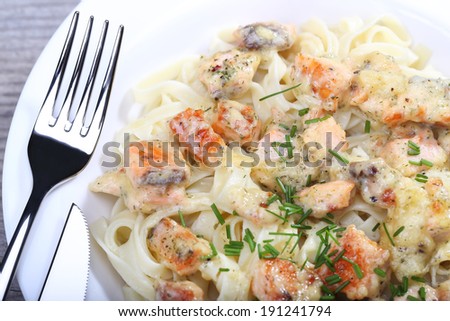 Pasta with salmon sauce and onion