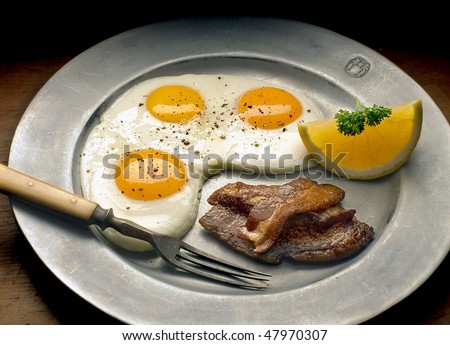 Eggs bacon on pewter plate