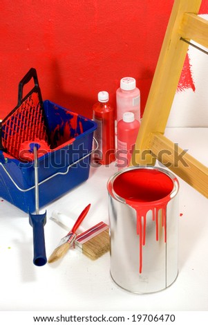 Red painting with ladder, roller brush, bucket and red pigments