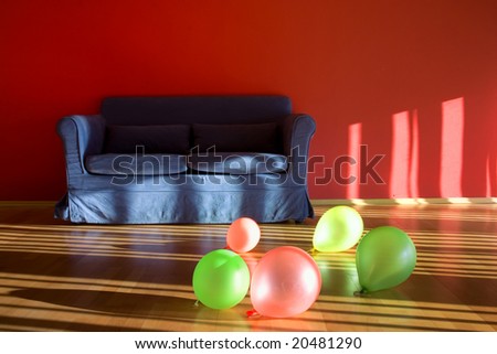 Red room with blue sofa with balloons