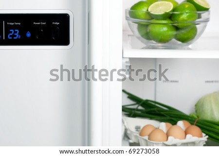 Refrigerator full with some kinds of food - fruits, vegetable and eggs