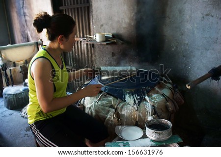 BA RIA, VIET NAM- FEBRUARY 2 .Woman make girdle cake (banh trang) - is the usual rice flour\'s cake of Viet Nam- at trational trade village, Ba Ria, February 2, 2013