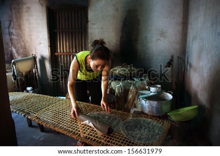 BA RIA, VIET NAM- FEBRUARY 2 .Woman make girdle cake (banh trang) - is the usual rice flour's cake of Viet Nam- at trational trade village, Ba Ria, February 2, 2013