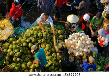 DA LAT, VIET NAM- FEBRUARY 8. People buy coconut fruit for Viet Nam Tet at market in Dalat, VietNam- February 8, 2013