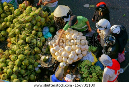 DA LAT, VIET NAM- FEBRUARY 8: People sell and buy coconut at farmers market in  Dalat, Viet Nam- February 8, 2013