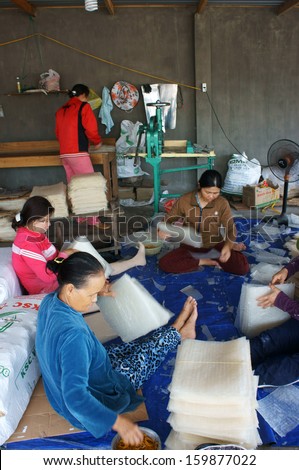 BINH THUAN, VIET NAM- FEBRUARY 4: Group of woman working to make Vietnamese traditional food at girdle cake  workshop in Binh Thuan, VietNam on February 4, 2013
