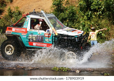 BAO LOC, VIETNAM- FEB 24, 2014: Racer at terrain racing car competition,motor cross stream that extreme off road with rock on water, competitor  adventure in championship spirit, Viet Nam