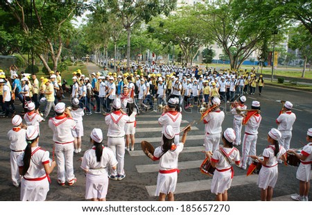 HO CHI MINH, VIET NAM- APRIL 6: Social crowded activity, impression with crowd of young people join charitable walking for community, many people in uniform, walk on street , Vietnam, April 6, 2014