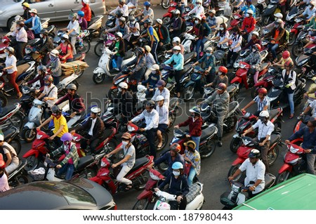 HA HOI, VIET NAM- APRIL 18: Amazing traffic of Asia city, group citizen on private vehicle in rush hour, colorful scene, mob of people in helmets, riding motorcycles, Hanoi, Vietnam, April 18, 2014