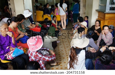 HO CHI MINH CITY, VIETNAM- JULY 9: Overload at Asia clinic, crowd of sick person standing, waiting to submit hospital fee, crowded of patient is situation, society problem, Viet Nam, July 9, 2014