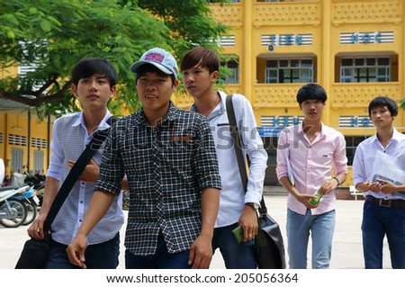 HO CHI MINH CITY, VIETNAM- JULY 15: Group of Vietnamese high school student finish university entrance exam, schoolboy walking in happy, this time is examination season in Viet Nam, July 15, 2014