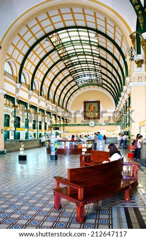 HO CHI MINH, VIETNAM- AUG 21: Beautiful interior in postal center, an ancient french post office with dome design for travel, traveller visit, sit on bench to relax, Vietnam, Aug 21, 2014