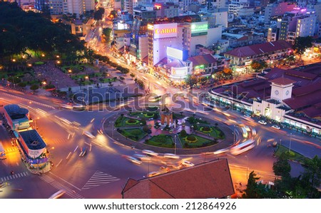 HO CHI MINH CITY, VIETNAM- AUG 21: Impression, colorful, vibrant scene of Asia traffic, dynamic, crowded city with trail on street, Quach Thi Trang roundabout at Ben Thanh market, Vietnam, Aug 21,2014