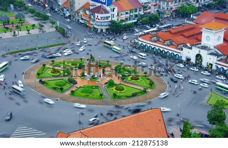 HO CHI MINH CITY, VIETNAM- AUG 21: Impression scene of Asia traffic, dynamic, crowded city with group of motorbike move on street, Quach Thi Trang roundabout at Ben Thanh market, Vietnam, Aug 21,2014