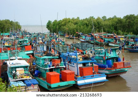 MEKONG DELTA, VIETNAM- JUL 27: Beautiful scene of fishing port, group of colorful fishing boat anchor on river, the canal cover by green mangrove forest, crowd landscape on water,Vietnam, Jul 27, 2014