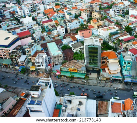 HO CHI MINH, VIETNAM- AUG 14: Amazing view of Asia city, group of private house from dense residence, vehicle move on street, urbanization urban, make increase greenhouse effect, Vietnam, Aug 14, 2014