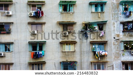 HO CHI MINH CITY, VIET NAM- SEPT 11: Impression scene of cement wall from old apartment building, group of aged window, air conditioner, block downgrade make unsafe, danger, Vietnam, Sept 11, 2014