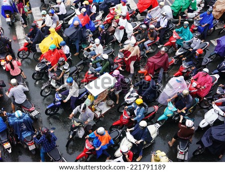 HO CHI MINH CITY, VIET NAM- OCT 6: Impression, colorful scene of Asia city in rush hour after rain evening, crowd of Vietnamese people wear raincoat, on motorbike, crowded on street, Vietnam, Oct 6, 2014