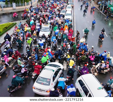 HO CHI MINH CITY, VIET NAM- OCT 6: Impression traffic jam scene of Asia city in rush hour on rain day, crowd of Vietnamese people wear raincoat, on motorbike, crowded on street, Vietnam, Oct 6, 2014