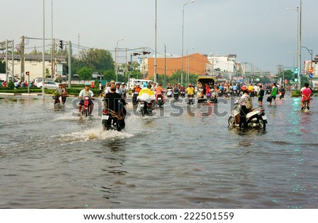 HO CHI MINH CITY, VIETNAM- OCT 9: Hard to circulate situation at Ho Chi Minh city when flood tide, flooded water on street, vehicle traffic in water, danger, unsafe scene, Vietnam, Oct 9, 2014