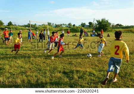 BINH THUAN, VIETNAM: Group of Unidentified Asian kid playing football in team, Vietnamese little boy run on grass, outdoor activity of children physical education at countryside, Viet Nam, Oct26, 2014
