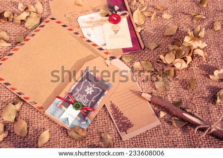Amazing Christmas card from ancient material; paper envelop with vintage style; wooden pen; dry leaf; abstract handmade Xmas card; send to friend with friendship and love