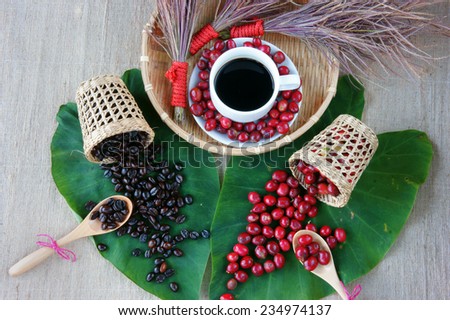 Harmony concept for advertise from coffee bean, cup of black cafe on ripe berries, basket of brown roasted coffe bean, flower to decor, set up on green leaf make amazing backgroud