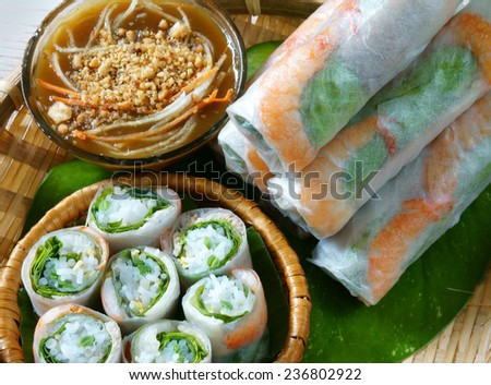 Vietnamese food, goi cuon is street food, roll that delicious, wrapped from shrimp, pork, vegetables, bun in rice paper, with accompaniments:  sauce, chili,  another name: salad roll, soft roll..