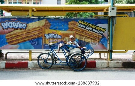 HO CHI MINH CITY, VIET NAM- NOV 17: Asian man relax on pedicab at bus Saigon station, Vietnamese male earn money by cyclo driver, a work hard for poor people, Vietnam, Nov 17, 2014