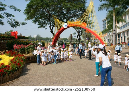 HO CHI MINH CITY, VIET NAM- FEB12: Group of unidentified Asian kid with outdoor activity of preschool, little boy, girl in uniform, Vietnamese children visit park in springtime, Vietnam, Feb 12, 2015