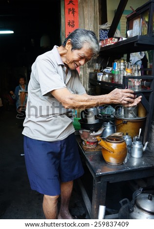 HO CHI MINH CITY, VIET NAM- FEB 7: Asian man with private business at home by cafe store, Vietnamese male earning money when elderly, ancient coffee shop with tradition make, Vietnam, Feb 7, 2015