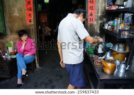 HO CHI MINH CITY, VIET NAM- FEB 7: Asian man with private business at home by cafe store, Vietnamese male earning money when elderly, ancient coffee shop with tradition make, Vietnam, Feb 7, 2015