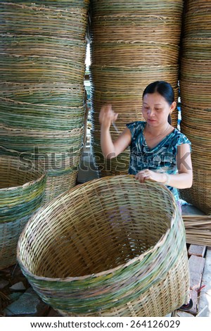 VINH LONG, VIET NAM- MAR 24: Asia trade village at Mekong Delta, Vietnamese people work inside to make basket from bamboo material, clever hand and hard working to make product, Vietnam, Mar 24, 2015