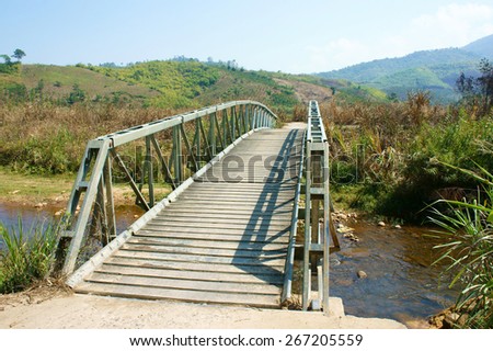 Small bridge cross stream at Vietnamese countryside, this bridge helps people go to the field safely