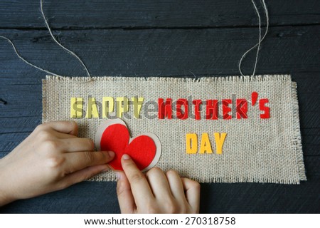 Happy mothers day with i love mom message,  idea from colorful letter on wooden background, woman hand cutting character to make gift for mother on happy day, show feeling with mother, love family