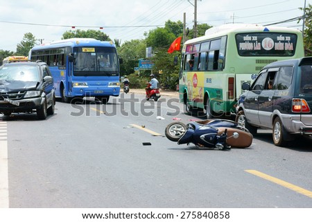 DONG NAI, VIET NAM- MAY 1: Traffic accident on highway 20, crowded of Vietnamese people on street, car crash with motorbike, crashed car, motorcycle lay on street, unsafe traffic, Vietnam, May 1, 2015