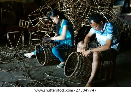 LAM DONG, VIET NAM- MAY 1: Vietnamese worker working inside of home at trade village  to make traditional product, rattan basket from nature material, clever hand, Vietnam, May1, 2015
