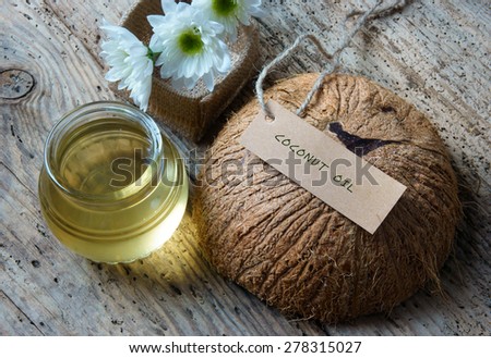 Coconut oil, essential oil from nature, a skin care that safe, rich vitamin, use in massage at spa, organic cosmetic on wooden background