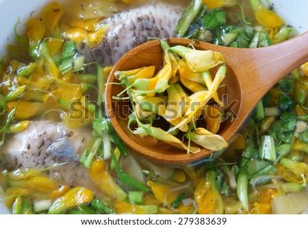 Vietnamese food, sour fish vegetable soup,  ingredients as fish, pineapple, tamarind, coriander, common sesban or bong dien dien, this nutrition eating is specific of Mekong Delta, Vietnam on summer