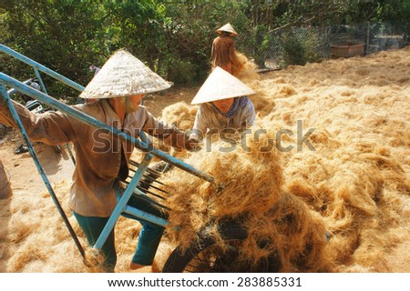 BEN TRE, VIET NAM- JUNE 1: Group of Asian worker work hard at coconut fiber trade village, Vietnamese woman working in dust, this is material area from coir of Mekong Delta, Vietnam, June 1, 2015
