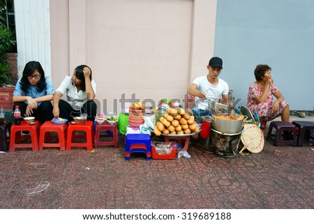 HO CHI MINH CITY, VIET NAM- DEC 17: Vietnamese street food, food vendor sale streetfood on pavement, this kind of eating very cheap, fast, can for snack or  meal of day, Saigon, Vietnam, Dec 17, 2104
