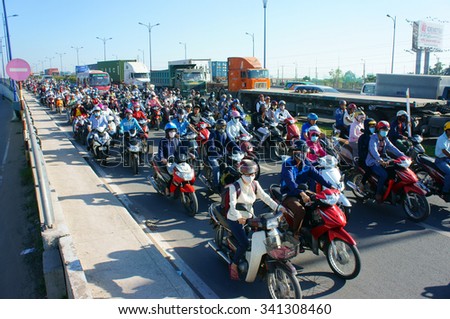 HO CHI MINH CITY, VIET NAM- NOV19: Crowded of motorcycle, moving transfer on street in rush hour, dusty, CO2, exhaust fumes from vehicle, overload Asia urban, environment problem, Vietnam, Nov19, 2015