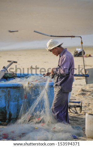Phuoc Hai, Viet Nam - Sep 7: A fisherman is working on the beach at the fishing village of Phuoc Hai, Vietnam on September 7, 2013. Phuoc Hai is a fishing village in the Binh Thuan of southeastern Vietnam.