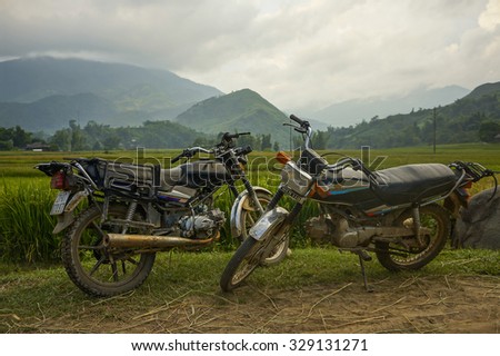 Tu Le town, Lao Cai province, Viet Nam, September 25, 2015: Two Honda Win motorbikes parked on a field.