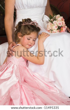 Blond Flower girl wearing a pink dress with bead-work