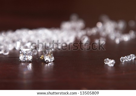 Diamond Earrings amongst glass stones that look like diamonds