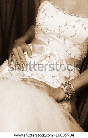 stock photo Bride sitting down close up of detail on wedding gown